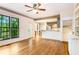 Open-concept living area with hardwood floors, featuring a bar, and a view to the outside at 404 Summerchase Way, Woodstock, GA 30189