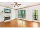 Bright living room with fireplace and views of the wooded outdoors from the door and windows at 404 Summerchase Way, Woodstock, GA 30189