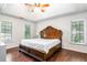 Spacious main bedroom featuring a trey ceiling, large windows, and hardwood floors at 404 Summerchase Way, Woodstock, GA 30189