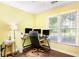 Bright office features dual windows, wood floors and desk space for a productive work environment at 404 Summerchase Way, Woodstock, GA 30189