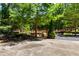 Outdoor seating and picnic area with mature trees and a charming bridge in the background at 404 Summerchase Way, Woodstock, GA 30189