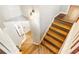 Interior shot of wood staircase with white risers leading to a bright second floor of the house at 404 Summerchase Way, Woodstock, GA 30189