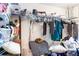 Messy walk-in closet with wire racks, rods, and piles of clothing and other items at 404 Summerchase Way, Woodstock, GA 30189