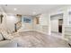 Finished basement with hardwood style flooring, staircase, and open floor plan with furniture at 5172 Roswell Rd, Marietta, GA 30062