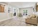 Spacious finished basement with a sitting area, white columns, and sliding glass doors to the outside at 5172 Roswell Rd, Marietta, GA 30062