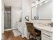 Well-lit bathroom featuring double sinks, vanity area, and a glass enclosed shower at 5172 Roswell Rd, Marietta, GA 30062