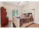 Comfortable bedroom with a well-decorated bed, wooden floors, and a view of the trees at 5172 Roswell Rd, Marietta, GA 30062