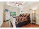 Charming bedroom featuring a decorative wooden bed frame, dark wood floors, and a ceiling fan at 5172 Roswell Rd, Marietta, GA 30062