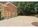 Spacious three-car garage with ample parking space and a basketball hoop in the driveway at 5172 Roswell Rd, Marietta, GA 30062