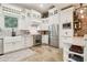 Modern kitchen with white cabinets, stainless steel appliances, stone floors and an island with bar seating at 5172 Roswell Rd, Marietta, GA 30062