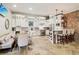 Spacious kitchen with white cabinets, stone floors, and a bar counter with seating at 5172 Roswell Rd, Marietta, GA 30062
