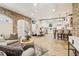 Open-concept living area with stone floors, a sofa, and a full kitchen with white cabinets at 5172 Roswell Rd, Marietta, GA 30062
