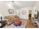 This living room features hardwood floors, a comfortable couch, and a decorative area rug at 5172 Roswell Rd, Marietta, GA 30062