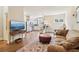 Open concept living room and kitchen featuring hardwood floors and modern stainless steel appliances at 5172 Roswell Rd, Marietta, GA 30062