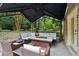 Inviting outdoor patio features comfortable seating and a beautiful outdoor fireplace, perfect for entertaining at 5172 Roswell Rd, Marietta, GA 30062