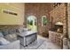 Outdoor patio featuring a brick fireplace, comfortable seating, and a view of the yard at 5172 Roswell Rd, Marietta, GA 30062