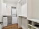 Walk-in closet with washer, dryer, wire basket storage, and built-in shelving at 5172 Roswell Rd, Marietta, GA 30062