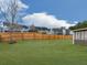 Large backyard with green grass and a tall wood fence bordering the property at 1510 Silver Mist Cir, Powder Springs, GA 30127