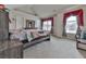 Bedroom featuring a large bed, red curtains, and neutral colored walls and carpet at 1510 Silver Mist Cir, Powder Springs, GA 30127