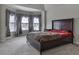 Bedroom featuring a large bed, and a bay window with decorative curtains and coverings at 1510 Silver Mist Cir, Powder Springs, GA 30127