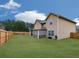 Exterior view shows the house, fenced backyard, and covered patio at 1510 Silver Mist Cir, Powder Springs, GA 30127