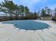 Community pool area, covered for the off-season, surrounded by tall trees at 1510 Silver Mist Cir, Powder Springs, GA 30127