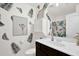 Nicely decorated bathroom with a modern vanity, leaf-themed wallpaper and a shower with leaf-themed curtain at 2333 White Oak Se Bnd, Smyrna, GA 30080