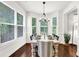 Bright dining room featuring a large bay window, hardwood floors, and modern chandelier at 2333 White Oak Se Bnd, Smyrna, GA 30080