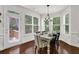 Dining area with a modern chandelier, lots of windows, hardwood floors, and access to the deck at 2333 White Oak Se Bnd, Smyrna, GA 30080