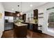 Modern kitchen with granite countertops, stainless steel appliances, and dark wood cabinetry at 2333 White Oak Se Bnd, Smyrna, GA 30080