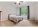Bright bedroom featuring a ceiling fan, neutral carpet, and a large window with backyard view at 3455 Henderson Dr, Cumming, GA 30041