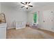 Cozy bedroom features natural light, carpet, and a white crib, creating a warm atmosphere at 3455 Henderson Dr, Cumming, GA 30041