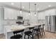 Modern kitchen with white cabinets, stainless steel appliances, and an island with bar seating at 3455 Henderson Dr, Cumming, GA 30041
