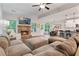 Spacious living room, dining area and kitchen with a fireplace, sofa, vaulted ceiling, and view of greenery at 3455 Henderson Dr, Cumming, GA 30041