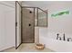Bathroom featuring a modern glass enclosed shower, soaking tub, neutral color tones, and plenty of natural light at 3455 Henderson Dr, Cumming, GA 30041