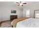 Comfortable main bedroom featuring wood flooring, television and view of the Main Bathroom at 3455 Henderson Dr, Cumming, GA 30041