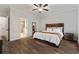 Comfortable main bedroom featuring wood flooring, a rustic wood bed frame, and neutral walls at 3455 Henderson Dr, Cumming, GA 30041