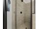 Modern bathroom featuring a tiled shower with a sleek, frameless glass door and black fixtures at 3455 Henderson Dr, Cumming, GA 30041