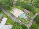 Aerial shot of community pool with parking and neighborhood clubhouse in distance at 4601 Tall Pines Nw Dr, Atlanta, GA 30327