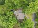 Aerial view of lush landscaping surrounding beautiful home with a stone pool and walkway at 4601 Tall Pines Nw Dr, Atlanta, GA 30327