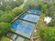Aerial view of well-maintained community tennis courts and clubhouse at 4601 Tall Pines Nw Dr, Atlanta, GA 30327