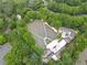 Elevated view of an outdoor amphitheater with tiered seating and a stage, surrounded by mature trees and ample parking at 4601 Tall Pines Nw Dr, Atlanta, GA 30327