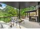 Outdoor deck with comfortable seating, perfect for enjoying views of the green backyard at 4601 Tall Pines Nw Dr, Atlanta, GA 30327