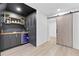Basement wet bar features stone countertop, custom cabinets, wine rack, and beverage refrigerator at 4601 Tall Pines Nw Dr, Atlanta, GA 30327