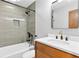 Renovated bathroom featuring modern fixtures, a new vanity, and stylish tile at 4601 Tall Pines Nw Dr, Atlanta, GA 30327