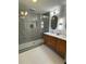 Modern bathroom featuring dual sink vanity, custom tilework, and glass enclosed shower at 4601 Tall Pines Nw Dr, Atlanta, GA 30327