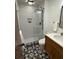 Cozy bathroom featuring modern fixtures, glass shower door, and patterned tile floor at 4601 Tall Pines Nw Dr, Atlanta, GA 30327