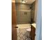 Cozy bathroom featuring modern fixtures, tub with shower, and patterned tile floor at 4601 Tall Pines Nw Dr, Atlanta, GA 30327