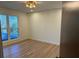 Bright bedroom featuring hardwood floors, a modern light fixture, and a large window allowing ample natural light at 4601 Tall Pines Nw Dr, Atlanta, GA 30327
