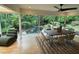 Bright dining room with a view of the natural stone pool and surrounding greenery at 4601 Tall Pines Nw Dr, Atlanta, GA 30327